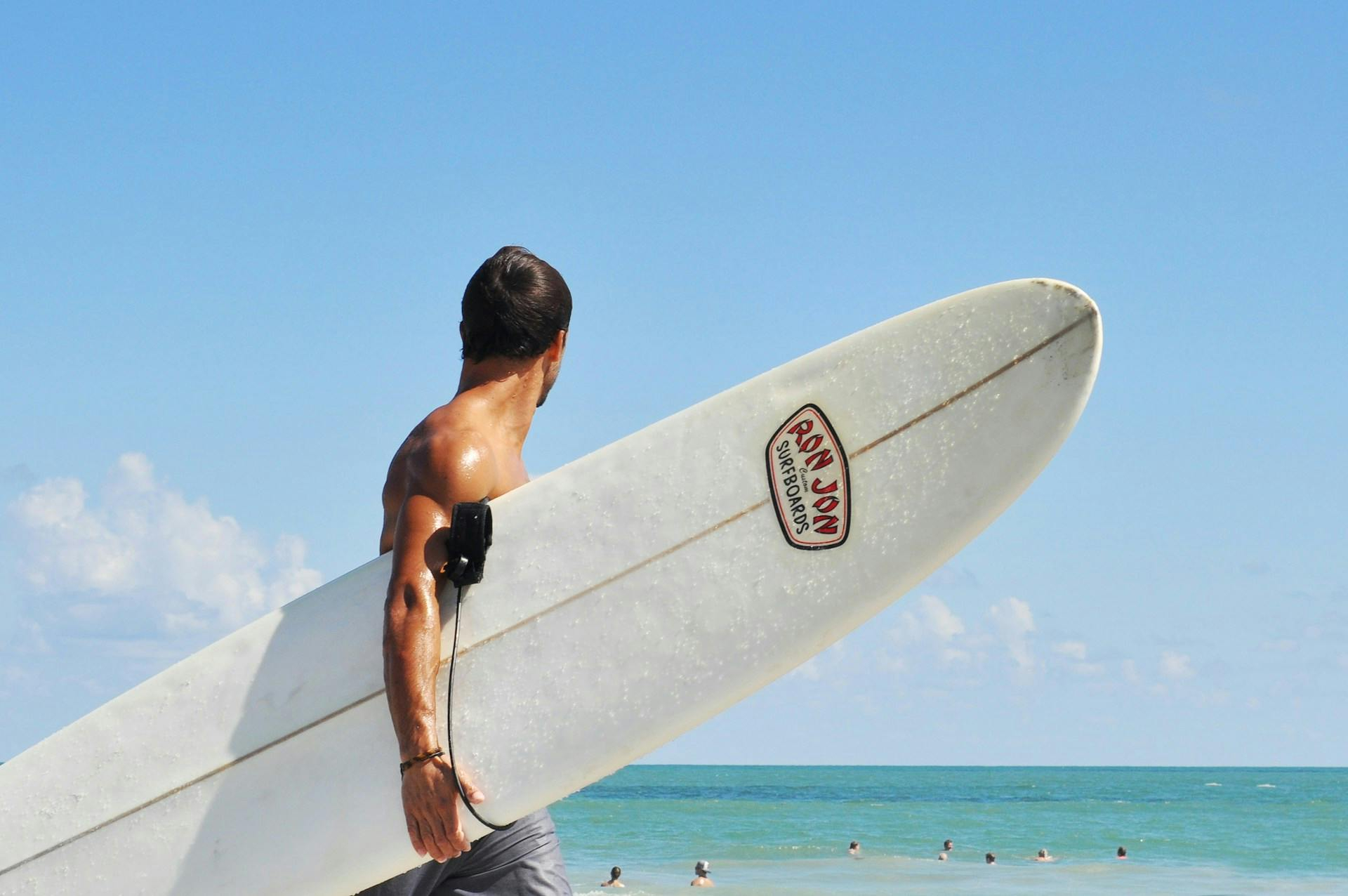 Surfer holding surfboard