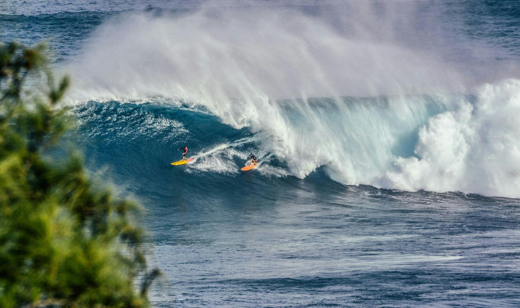 Two people surfing in Hawaii